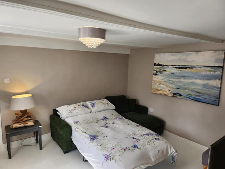 The snug has a second TV and a corner sofa that converts into a super comfortable sofa bed. Conveniently on the ground floor near the downstairs loo, it also functions as a walkthrough—just so guests are aware of the layout.