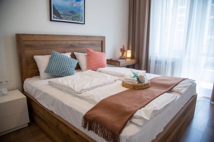 Comfortable King‑Size Bedroom
The spacious king-size bed is dressed in crisp linens, accented with decor and artwork that give the room a serene, homey feel.