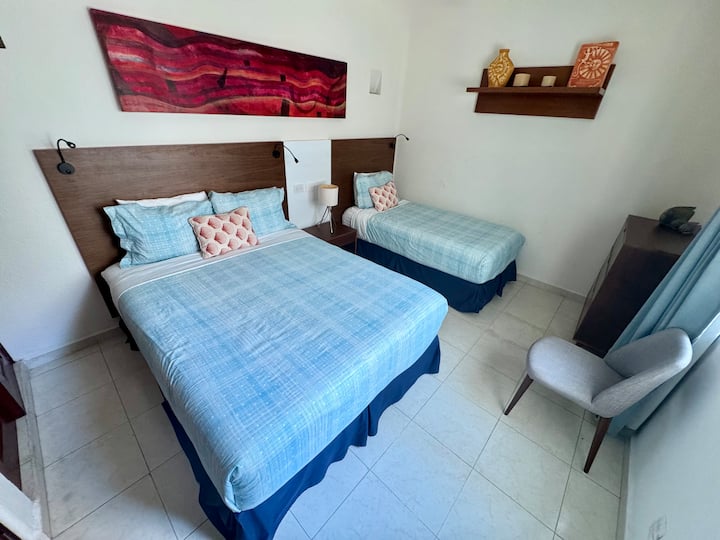 Large guest bedroom with one queen and one single bed. Sleeps three.