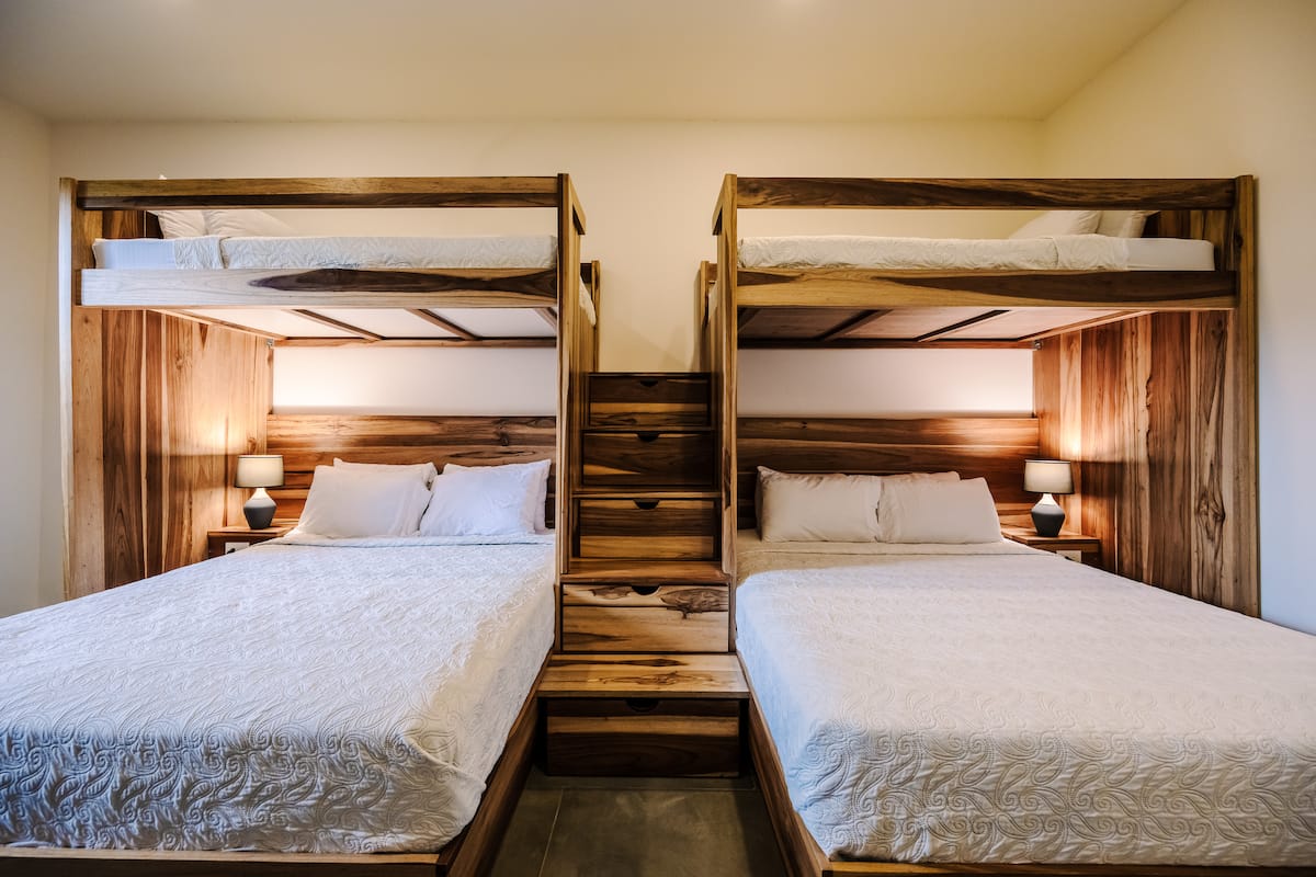 A bunk room: two queen beds with single bunks above