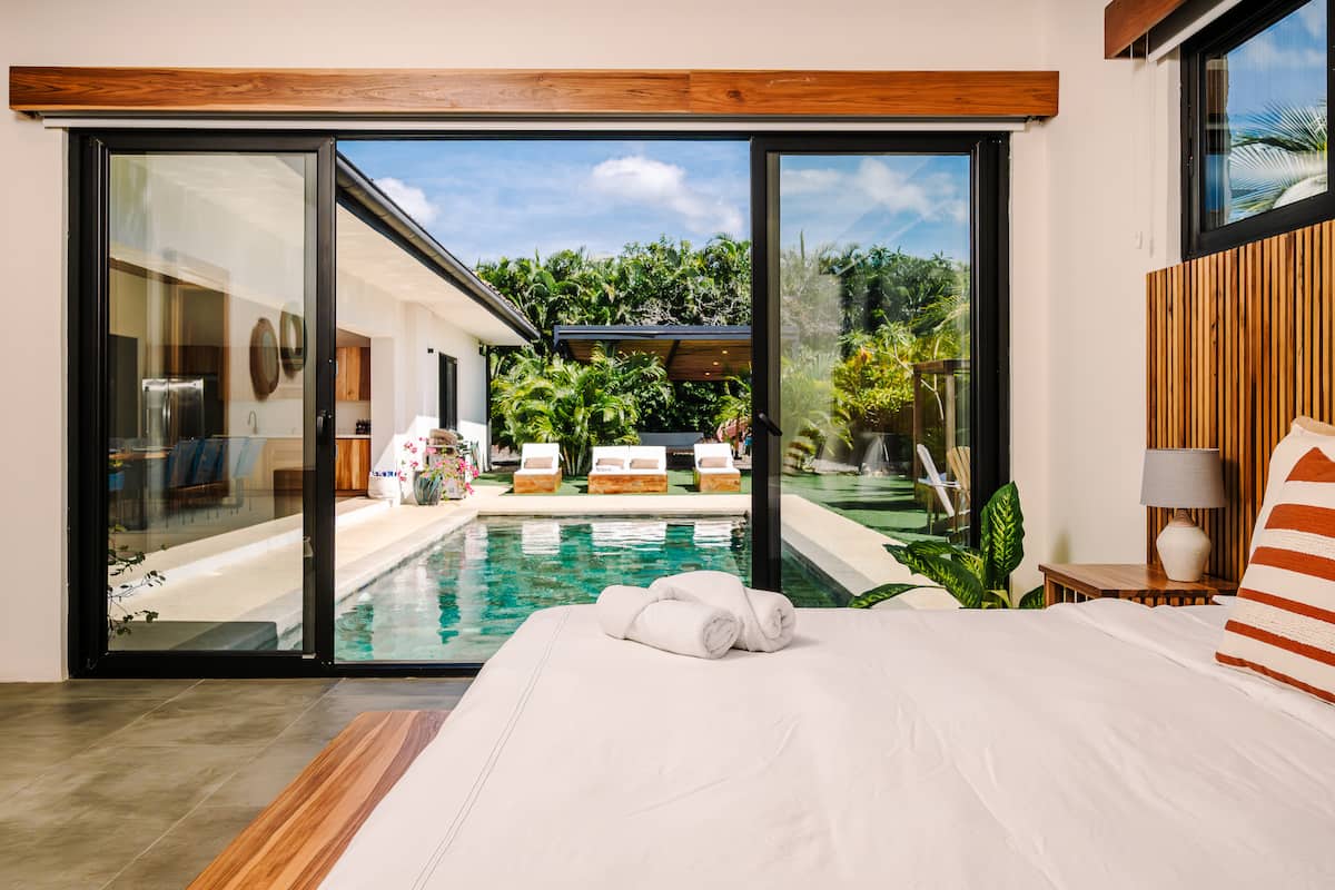 A king suite with glass doors onto the pool