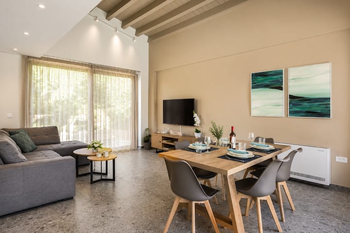 Relax in a bright, open-plan living space designed for comfort and effortless holiday living. Floor-to-ceiling windows fill the villa with natural light, while the comfortable lounge features a Smart TV with satellite channels and Netflix