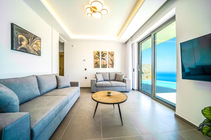 Step into an elegant and spacious living area, where a stylish seating arrangement and a 50” Smart TV create the perfect setting for cozy evenings. 