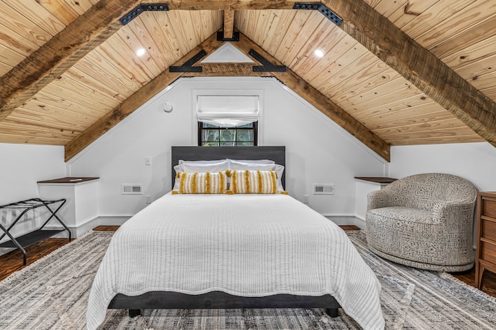 Upper loft sleeping area features a queen bed, wall mount fan, swivel chair and 6 drawer dresser. Note-this upper loft area does not have a door.