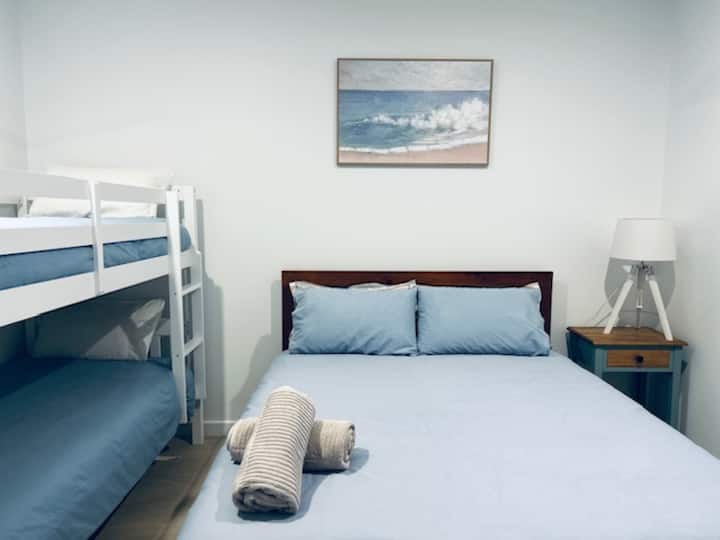 Queen size bed, 1 single bunk bed, wardrobe, power outlets, phone outlets, chair, spare pillows & blankets, ceiling fan, ducted air-conditioning.