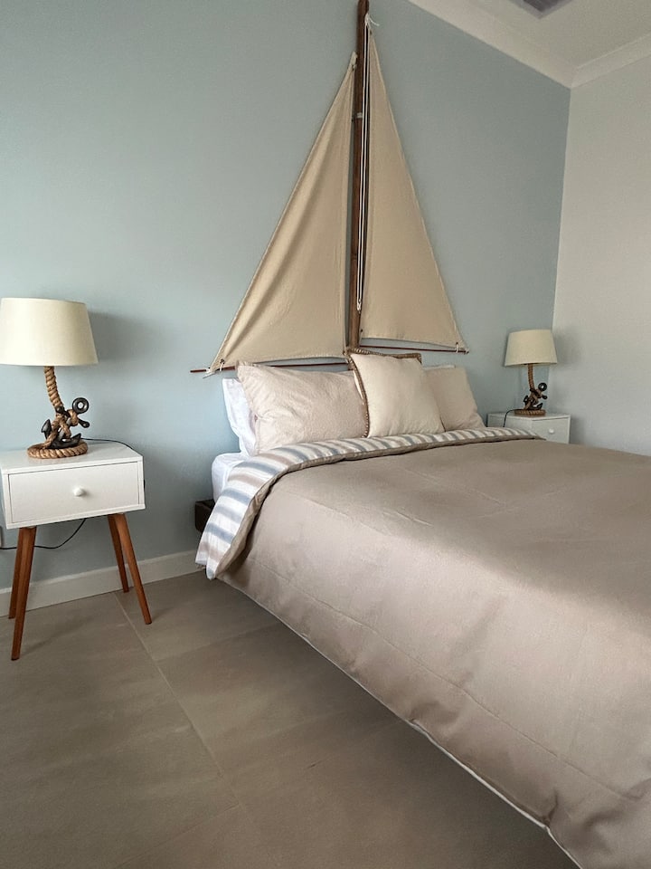 Queen size bed, ceiling fan, ducted air-conditioning, phone outlets, power outlets, hanging space, clothes storage, chair, full length mirror.