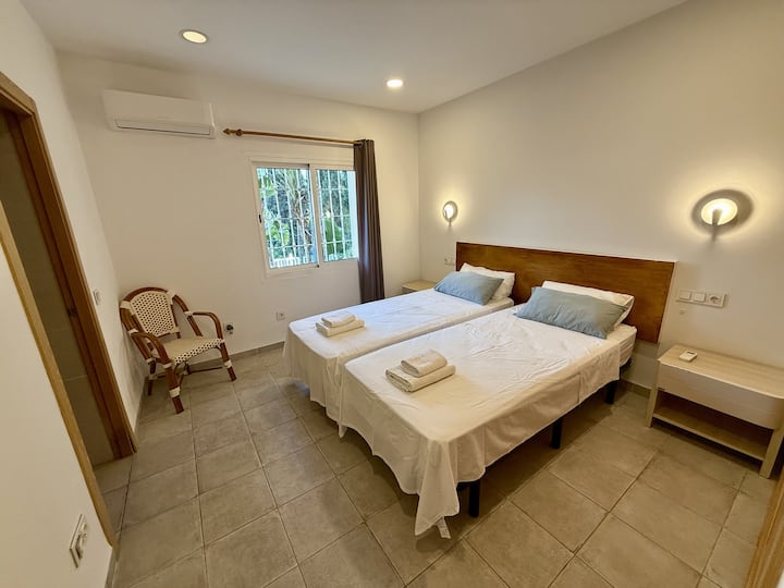 Bedroom 1 (with ensuite) ; two single beds, joining together for a King bed. Easy access to garden and pool area, with low level entrance.