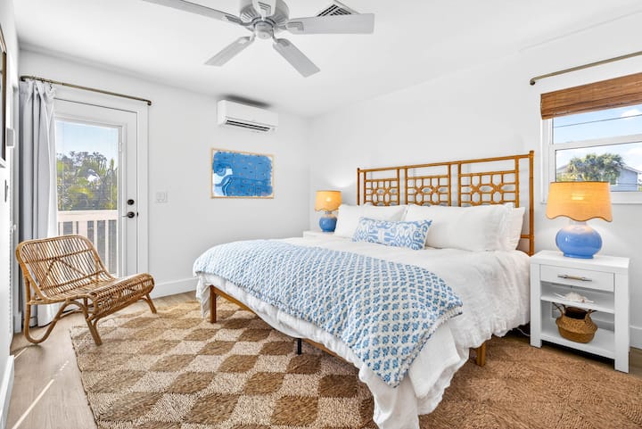 Guest bedroom on main level with King bed, luxe hybrid mattress and bedding, blackout curtains, mini-split for customized nighttime temps, ceiling fan, sound machine, and bathroom.
