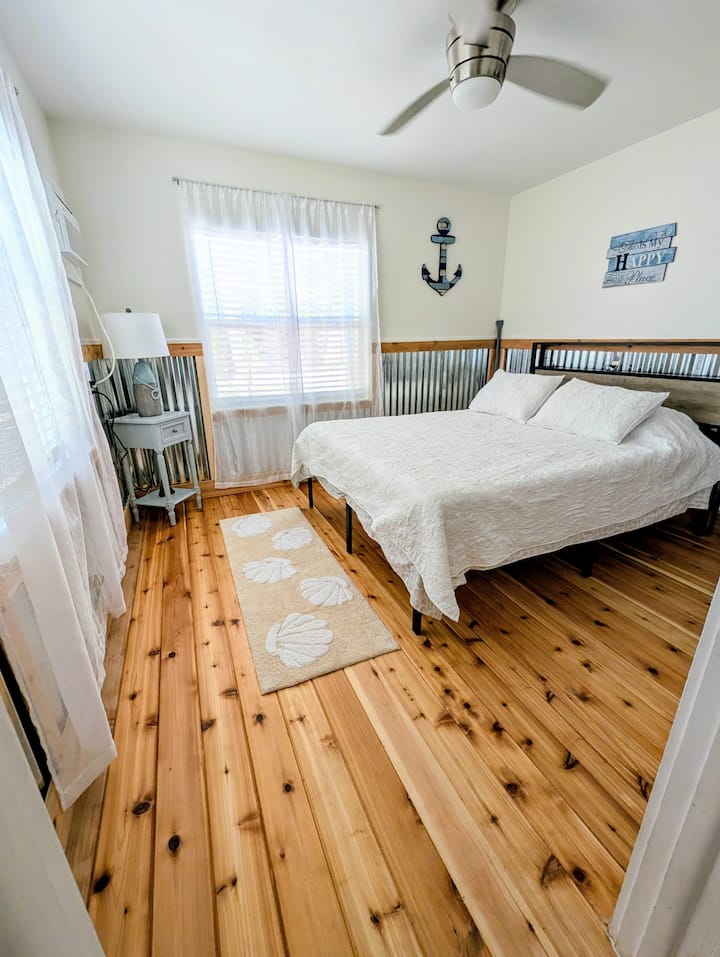 Mermaids call this room their happy place, sailors are welcome too. Queen memory foam mattress on a platform bed.