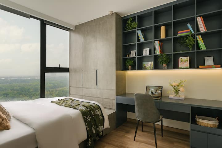 A bright bedroom with lake views and a comfortable work corner.