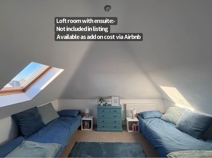 This loft space has two twin beds, a chest of drawers. cosy lighting. The room has a TV with Netflix and Disney.  Fast WIFI. This leads onto an ensuite bathroom with toilet, sink and shower. This space is not included in the listing but can be booked