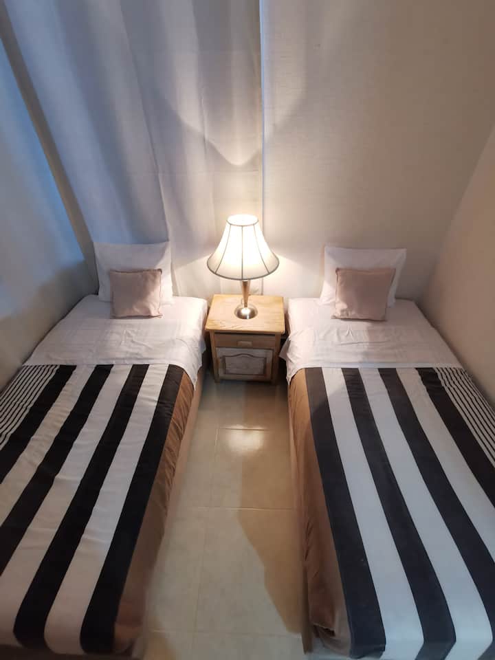 2 single beds with the option of becoming a king size bed for 3 people. 