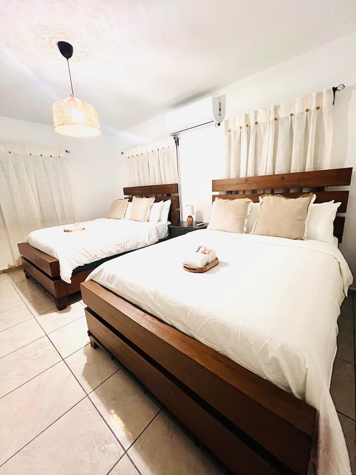 Designed for your group of 10! This spacious room in the main house features two comfortable queen beds, allowing four of your guests to sleep together with total ease.