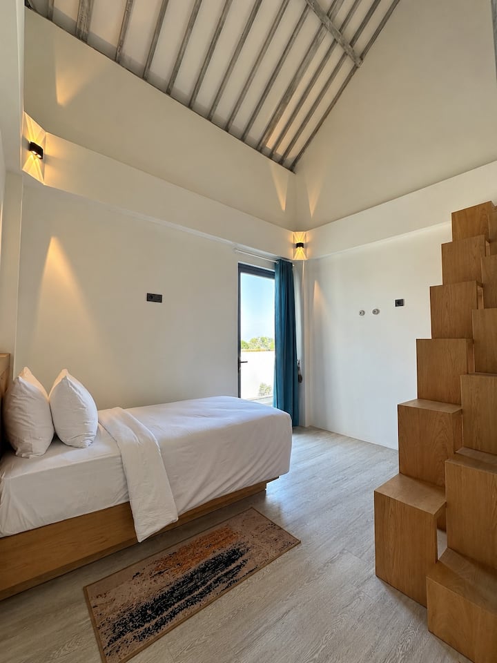 Bedroom 3, upstairs: a single bed plus a single mattress on the loft, air conditioning, en-suite bathroom and balcony
