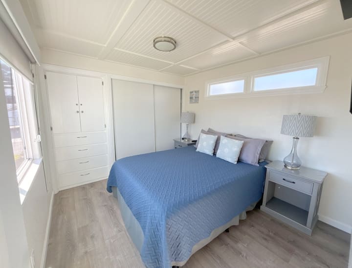 Queen bed, ocean view window with dual privacy shades