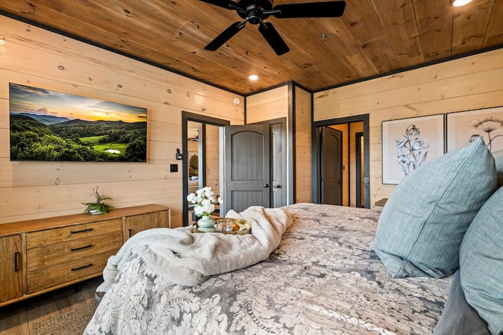 Cozy wood-accented bedroom with plush bedding and rustic charm