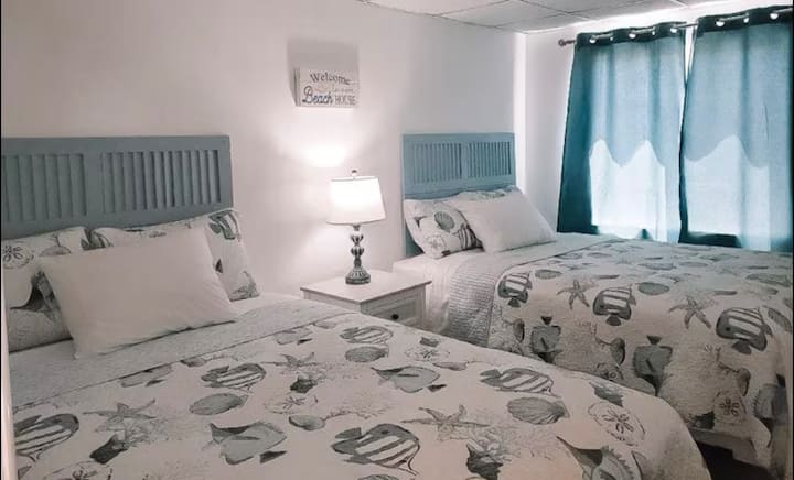 New plush queen mattresses.  Sheets, pillows and quilts are laundered between guests.  Iron and ironing board, portable hanging rack for hanging clothing.  A full-sized mirror hangs on the back of the door of the bedroom.  