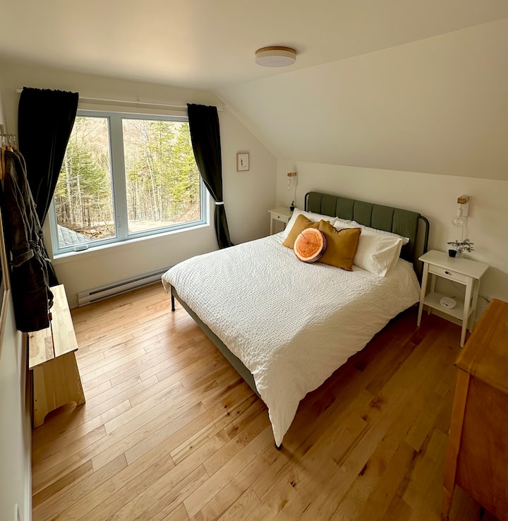 Large bedroom with queen-size bed, storage, and stunning views of nature!