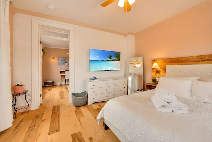 Queen bed with TV. 

You need to pass by the office to get to this room.