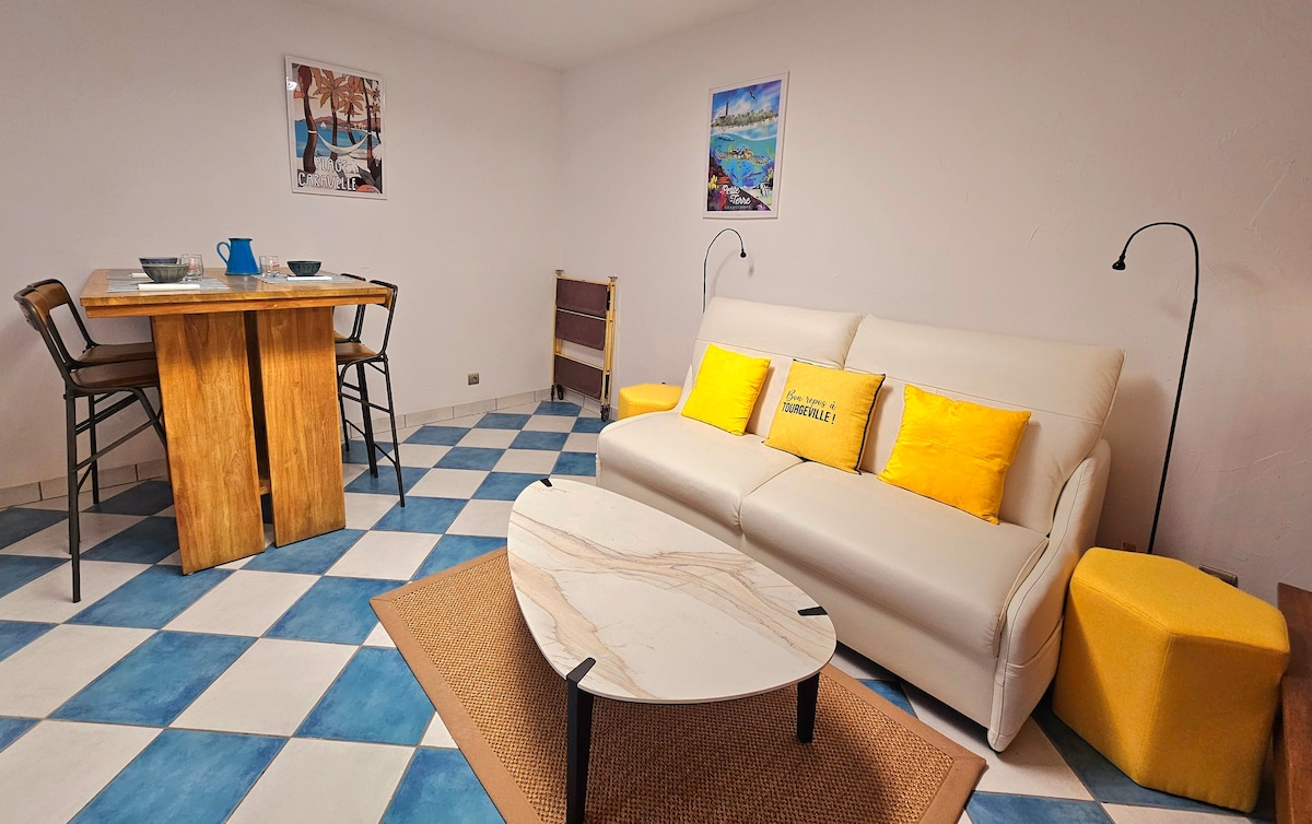 A cozy seating area is highlighted by a light-colored sofa adorned with yellow cushions. A wooden table is paired with high-backed chairs, while a marble coffee table sits on a neutral area rug. The floor features a striking blue and white checkered pattern.