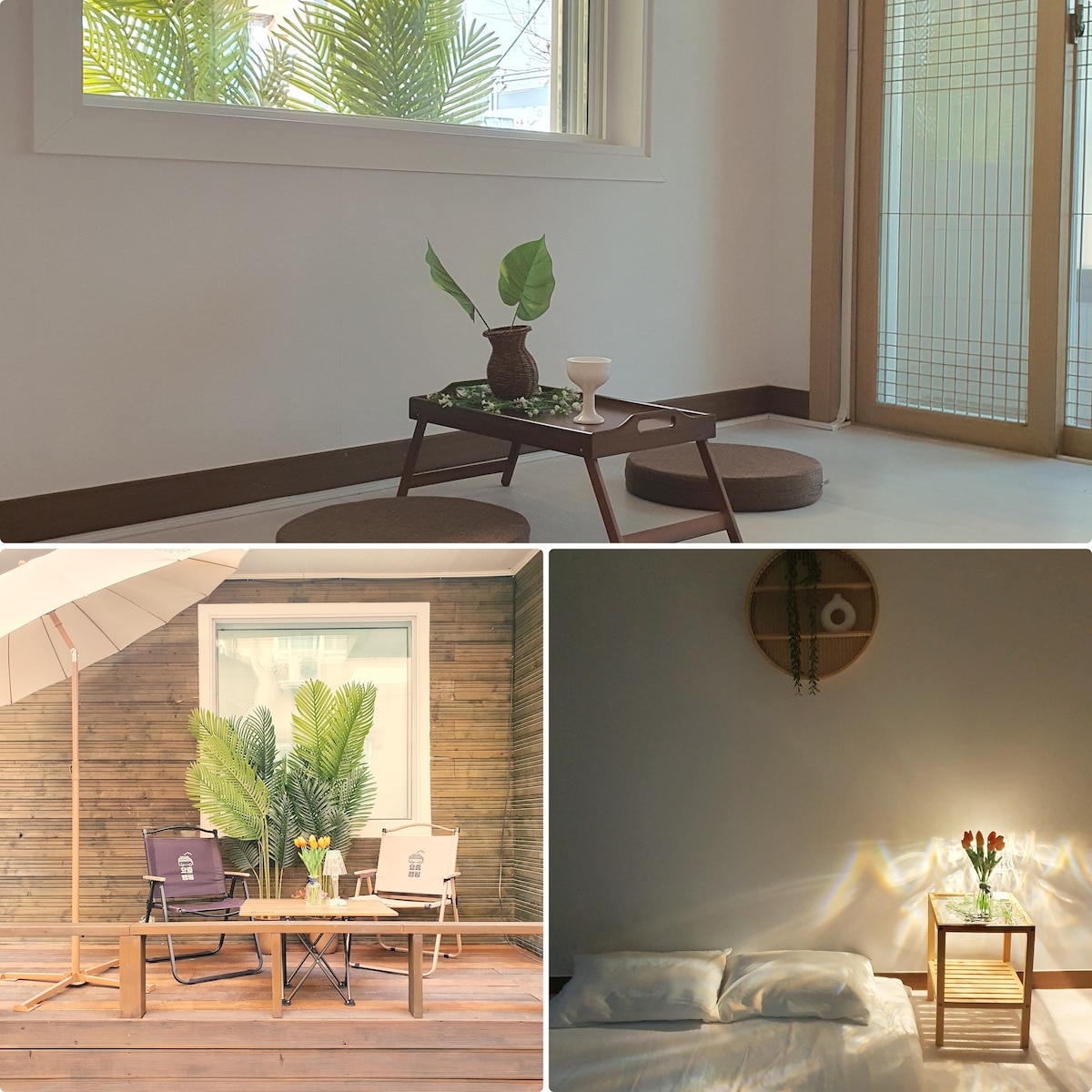 A bright living area features a minimalistic design with a potted plant atop a low table. Two comfortable cushions provide seating. A wide window allows natural light to enter, enhancing the serene atmosphere. The terrace displays outdoor seating under an umbrella, complemented by lush greenery.