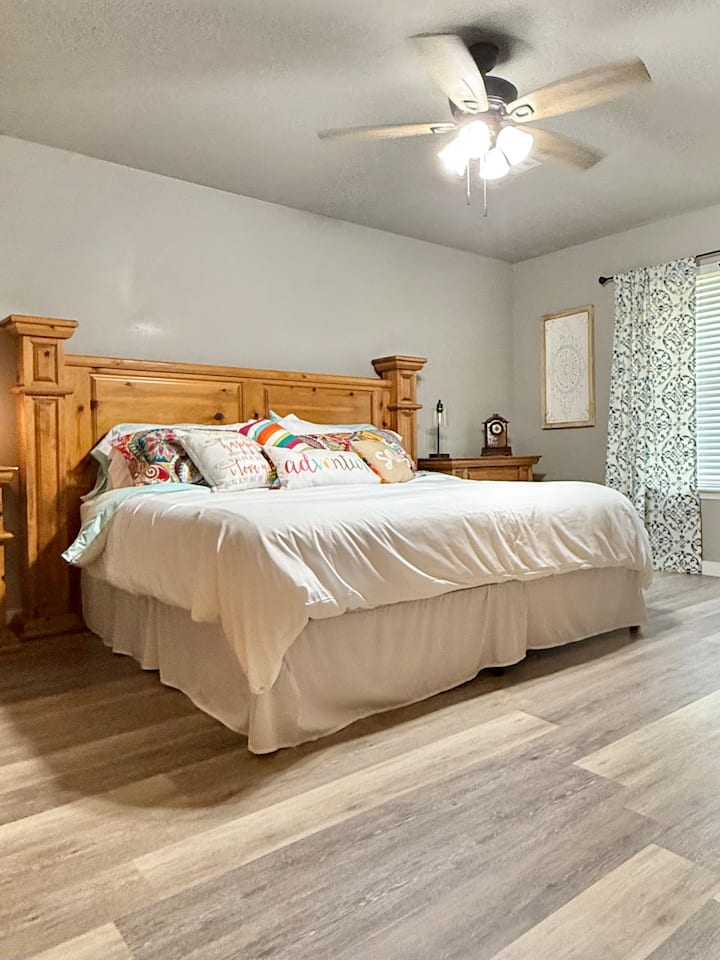 Comfortable and spacious master bedroom with king bed, smart TV and dedicated work area.