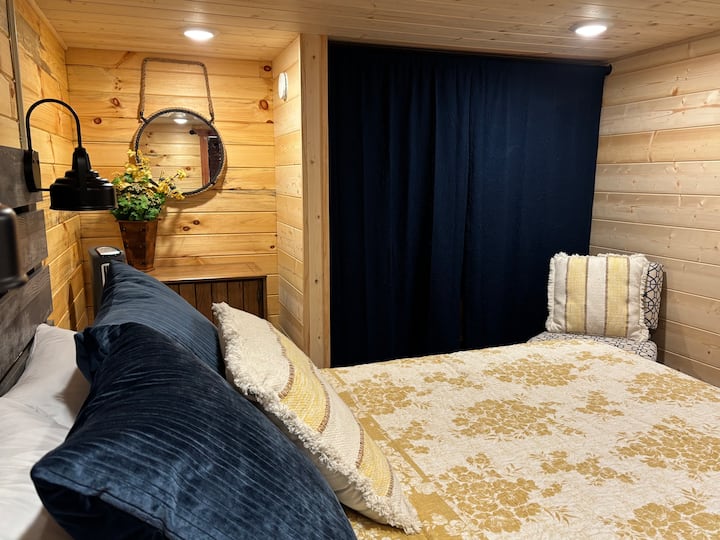 Behind this curtain is a closet with extra pillows and linens