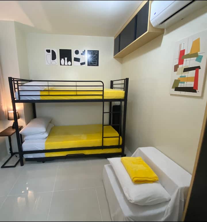 Air conditioned clean minimalist room with twin bunk beds plus a pull out bed and a folding single sofa/bed. Strong Wi-Fi signal.