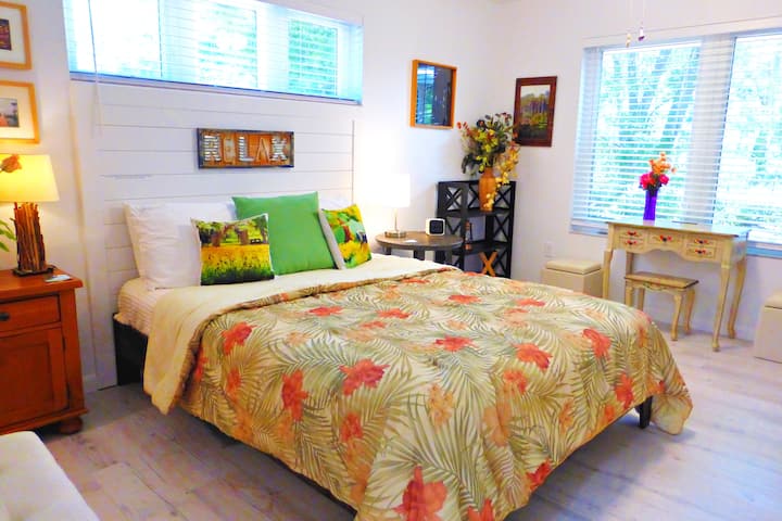 This Bungalow bedroom 2 is furnished with a queen bed, a walk-in closet, plenty of storage space and a private entrance to a shower bathroom that can also be used by visitors.  Blinds provide plenty of darkness for late sleepers.