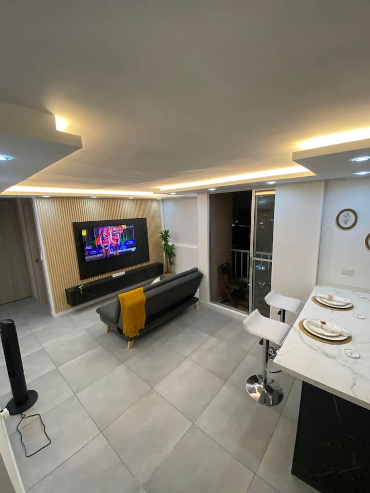 Spacious and inviting living room with plenty of natural light. Features a comfortable sofa bed perfect for extra guests. The open layout and cozy atmosphere make it ideal for relaxing or spending time with family and friends.