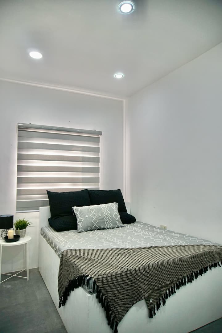 The master bedroom is on the first floor. It has its own TV. Bathroom is outside, adjacent to the room.