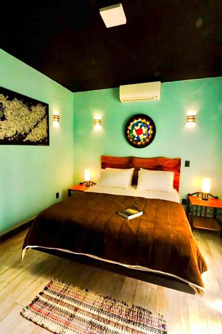 Room with queen-size bed, standard hotel bedding and air conditioning.