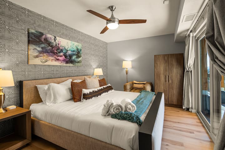 King bed with private slider to the hot tub and pool level.