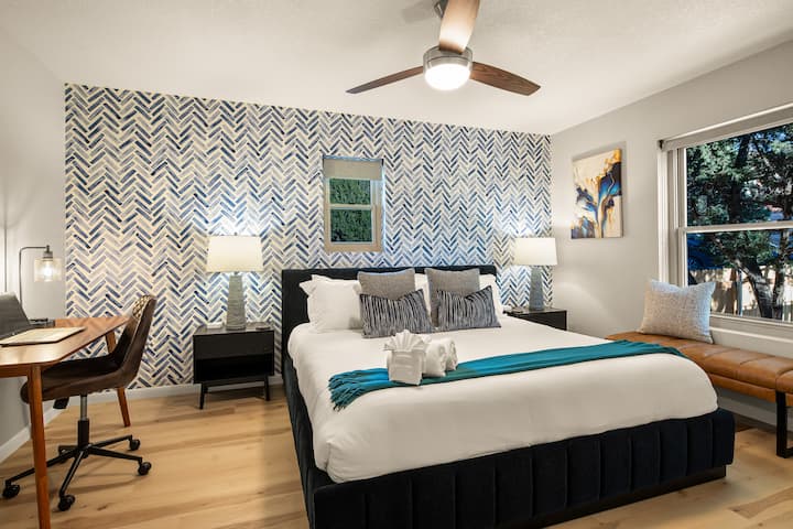 Upstairs bedroom with king bed and work desk.