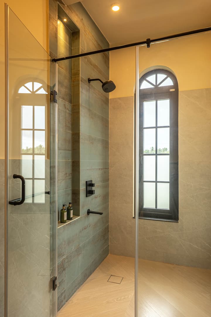 Refresh in a modern bathroom featuring hot water, complimentary toiletries, and elegant finishes. Designed for comfort during your luxury villa stay in North Goa.