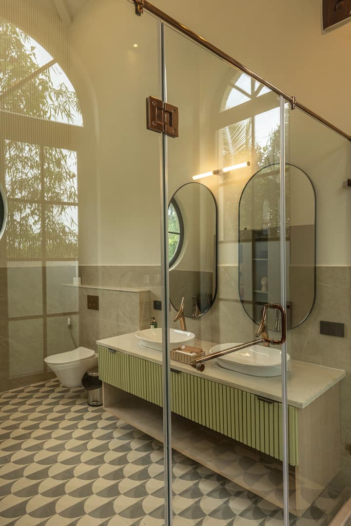 Enjoy the convenience of hot water, complimentary bathroom toiletries, and elegant modern interiors. A perfect addition to your luxury villa experience.