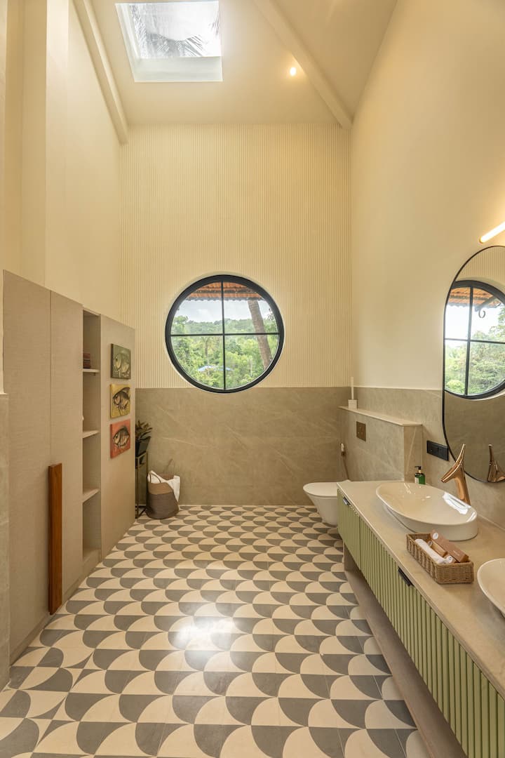 The modern bathroom features 24-hour hot water, fresh toiletries, and sleek finishes, offering comfort and convenience during your stay in North Goa.
