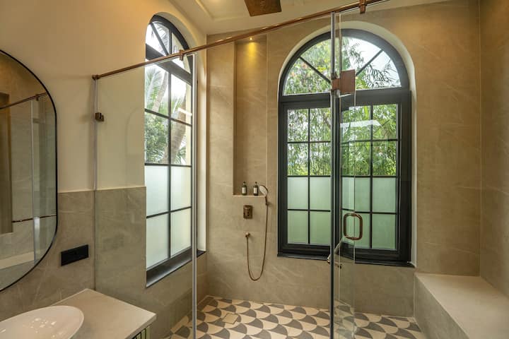 Designed with comfort in mind, the bathroom features hot water, essential toiletries, and stylish modern finishes. Ideal for a relaxing stay in Parra, North Goa.