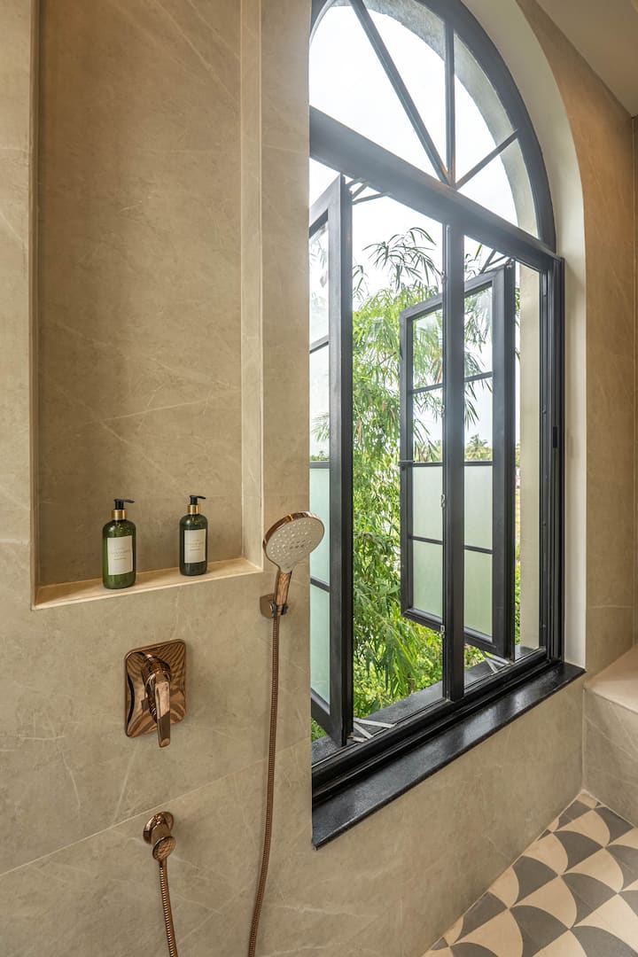 Relax in a clean, contemporary bathroom complete with hot water, toiletries, and premium modern finishes. Designed for a comfortable North Goa getaway.
