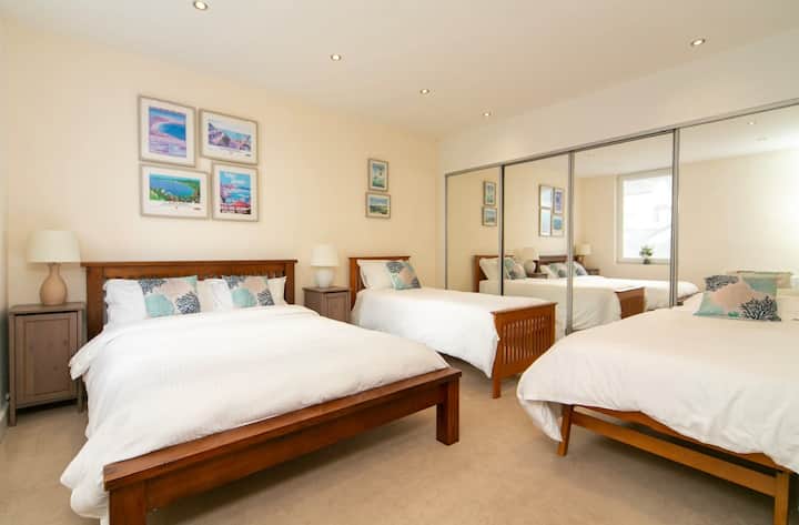 Bedroom three is ideal for families, with a king size bed and two singles. There is plenty of wardrobe space and an en-suite bathroom with walk in shower.