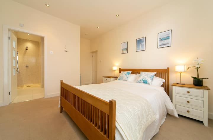 Bedroom two has a comfortable king size bed, TV and en-suite bathroom with walk in shower.
