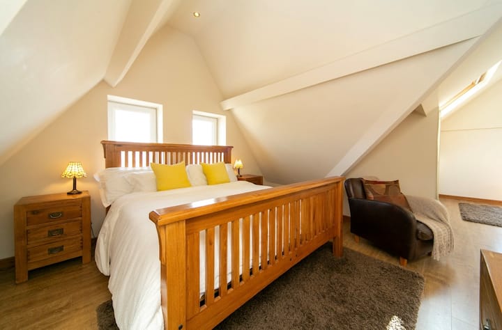 Our amazing attic room has a super king bed, en-suite bathroom and it's own private lounge area with TV, sofa and beautiful views of West Shore.