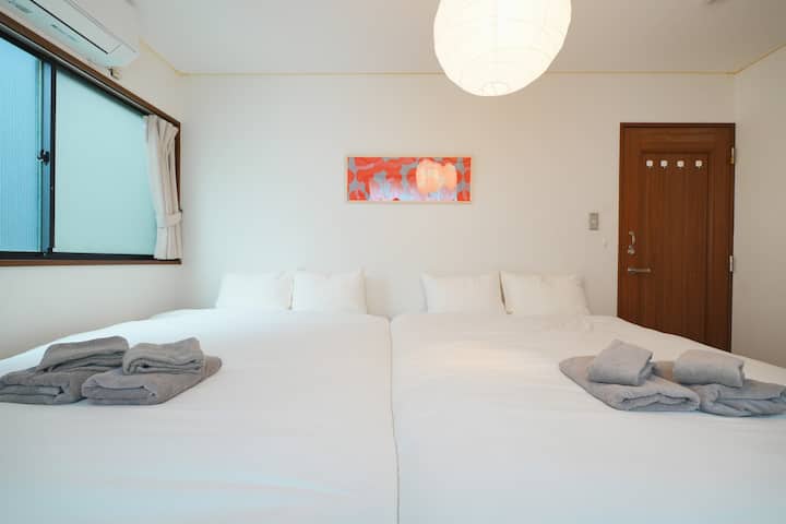 Daytime view of the bedroom with two double beds, ideal for up to four guests. A clean and cozy space for a restful stay.
The tall closet on the right is available for guests to use freely—for hanging coats or storing personal items during the stay.