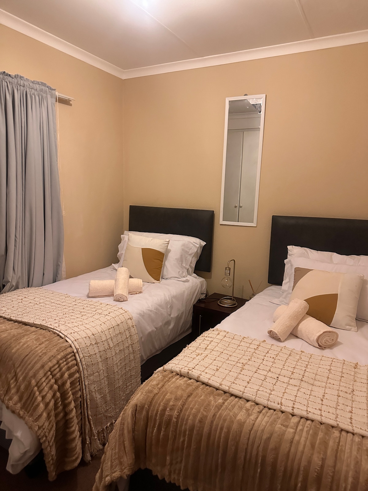 Bright and welcoming bedroom for family or friends — made for restful nights. Two win beds that can be combined into a Queen size bed 