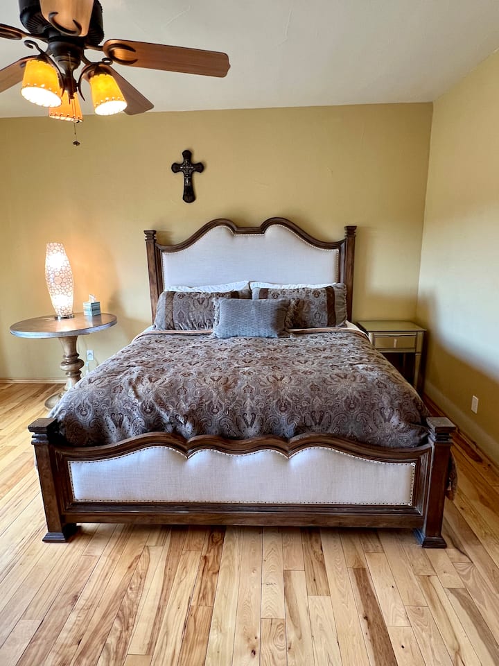 Camera da letto principale al piano terra con letto king size e patio privato con vista sulla valle