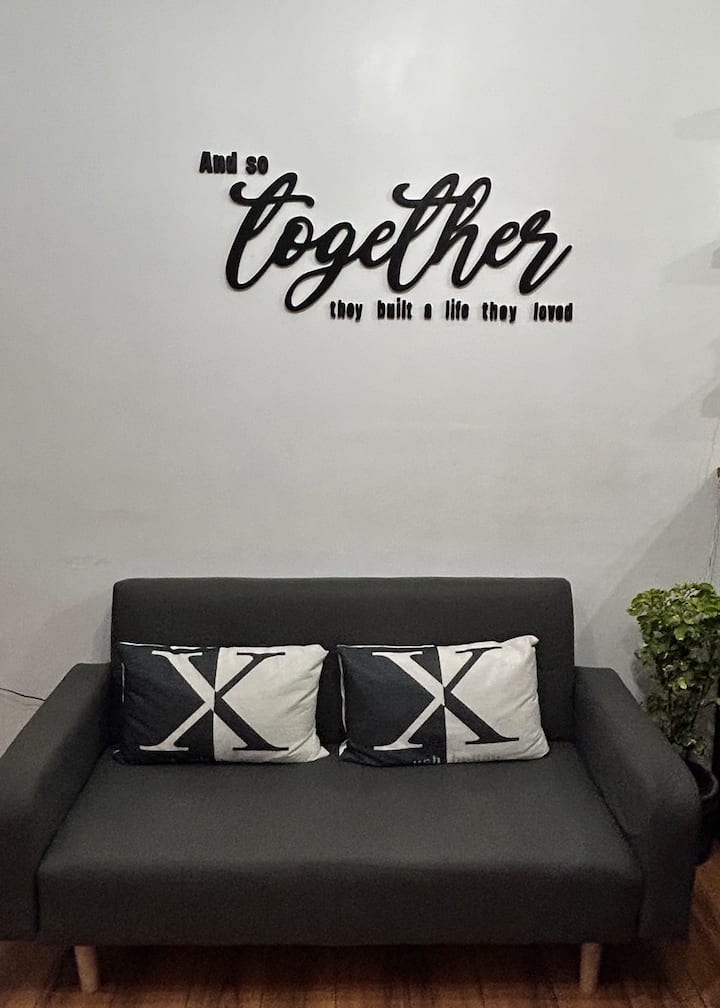 The living room is a comfortable space where guests can relax and unwind. It has a soft, cushioned 2-seater sofa that can be converted into a bed.
