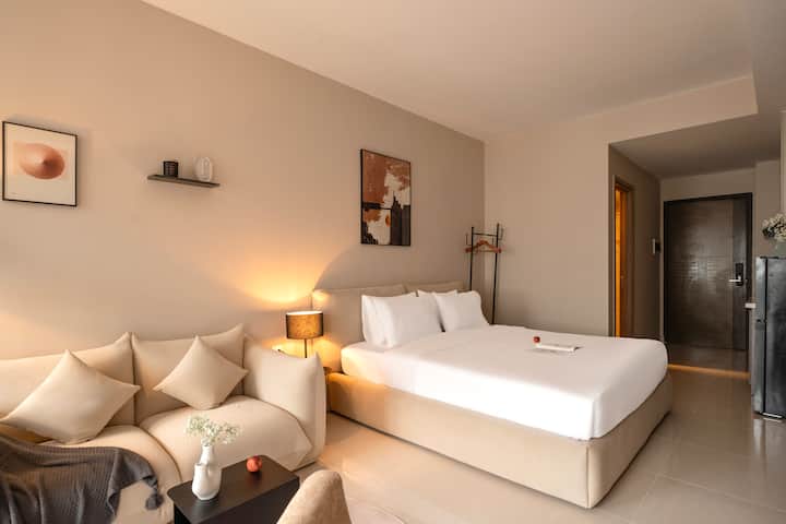View of the king size bed with hangers for your clothing