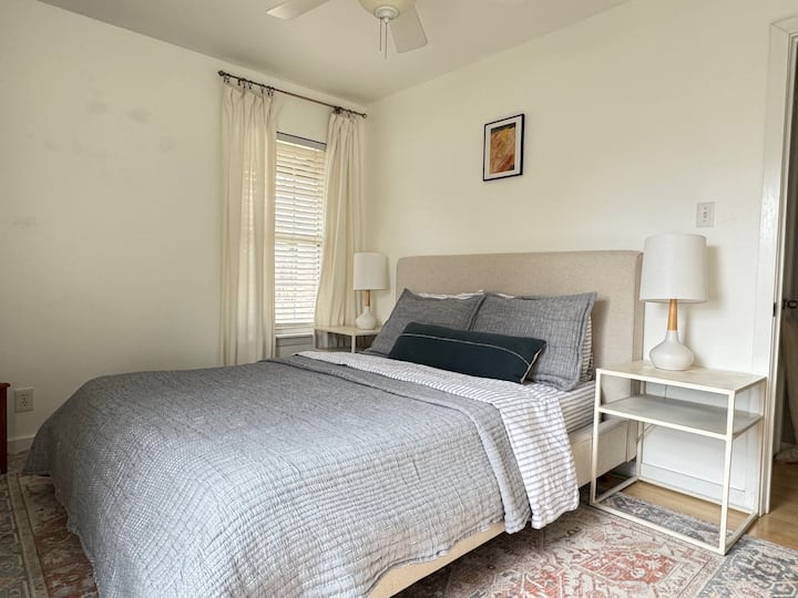 12x10' room with plush Persian carpet, organic bedding from Quince and a linen bed frame. Two windows let in plenty of gentle morning light. Quiet, peaceful sanctuary for thoughtful travelers.