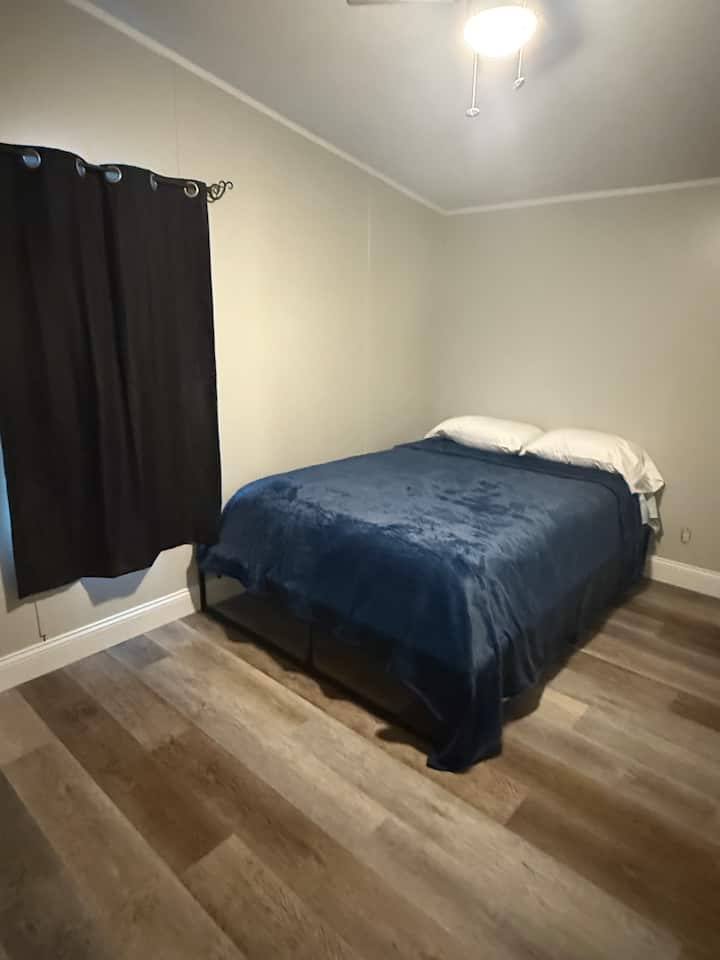 This room has a working tv hooked to wifi. A walk in closet and tall dresser and a sitting bench