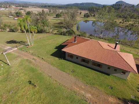 Farmhouse with fireplace and lake view.
